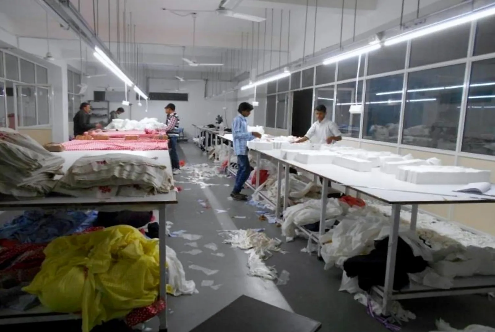 Cutting room with fabric laid on long cutting tables