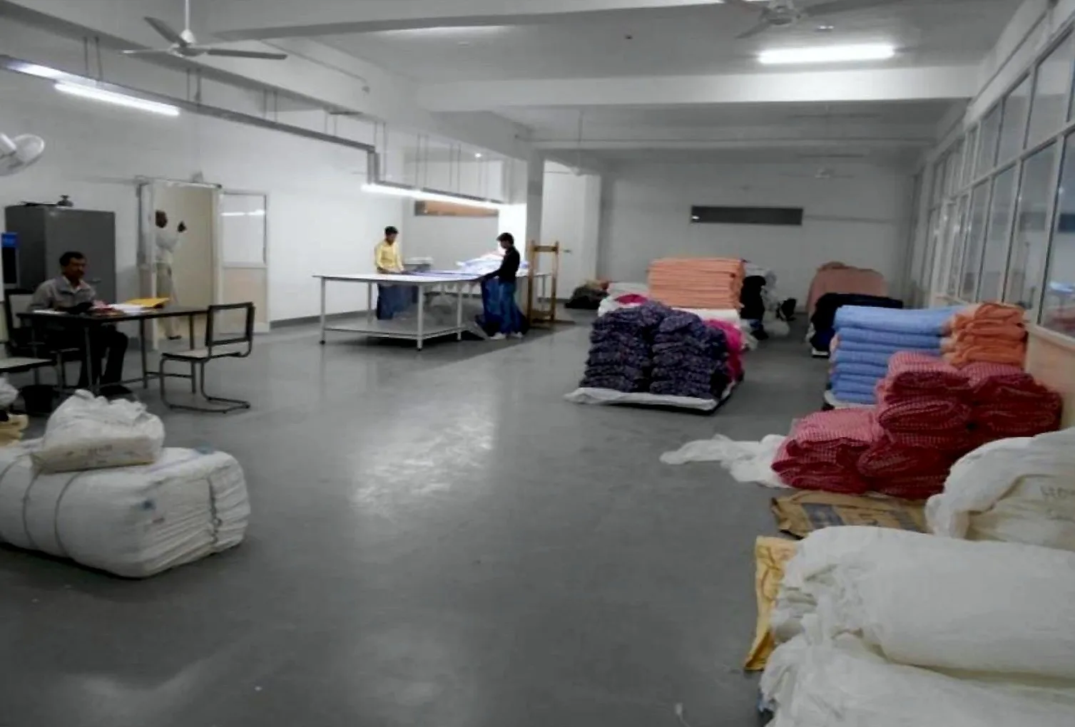 Fabric store with rolls and bales of incoming fabric at Shanaya Fashion's Gurugram factory