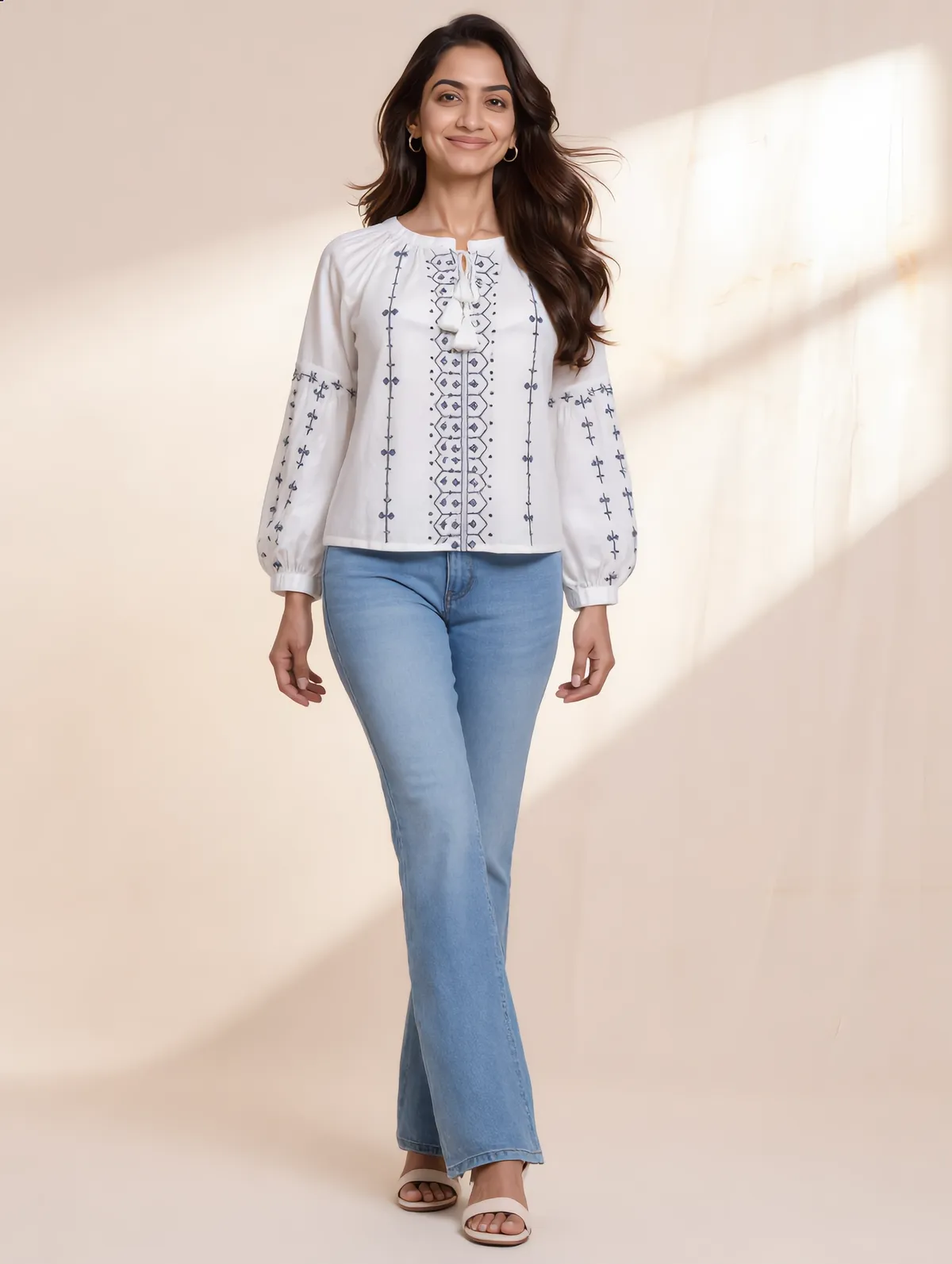 White cotton peasant blouse with tie neck, balloon sleeves and navy cross-stitch